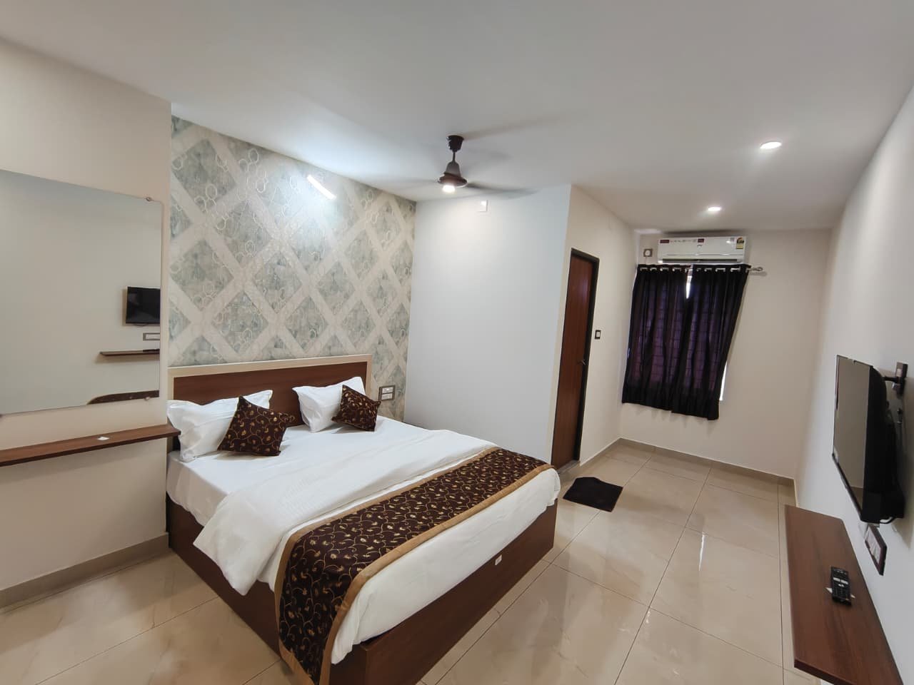 Well-appointed room at Radha Grand Inn